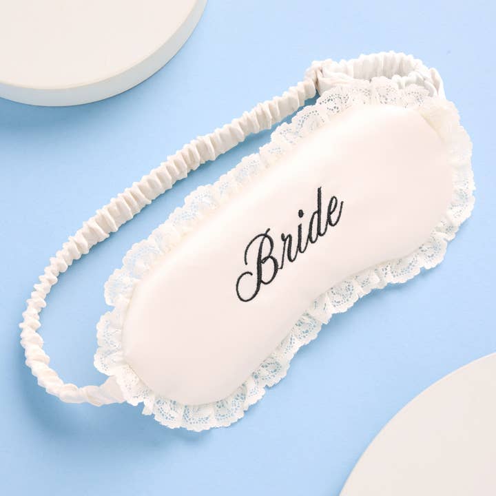 Sleep mask with 'Bride' text on a light blue background