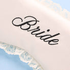 White pillow with 'Bride' embroidery on a light blue background
