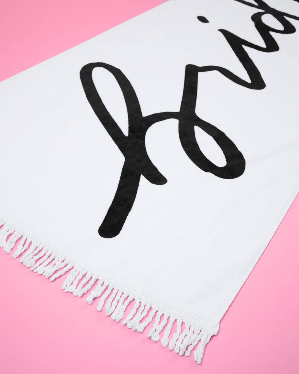 White scarf with black text on a pink background