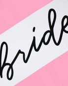 Black 'bride' text on a pink and white striped background