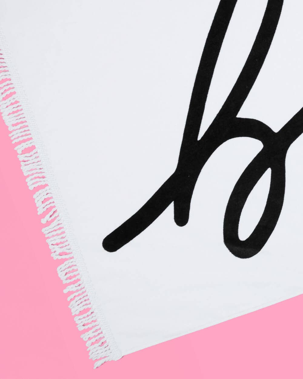 Close-up of a logo with a stylized 'B' on a pink and white background