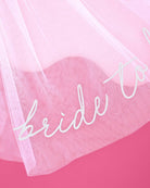 Sheer fabric with 'bride to be' text on a pink background