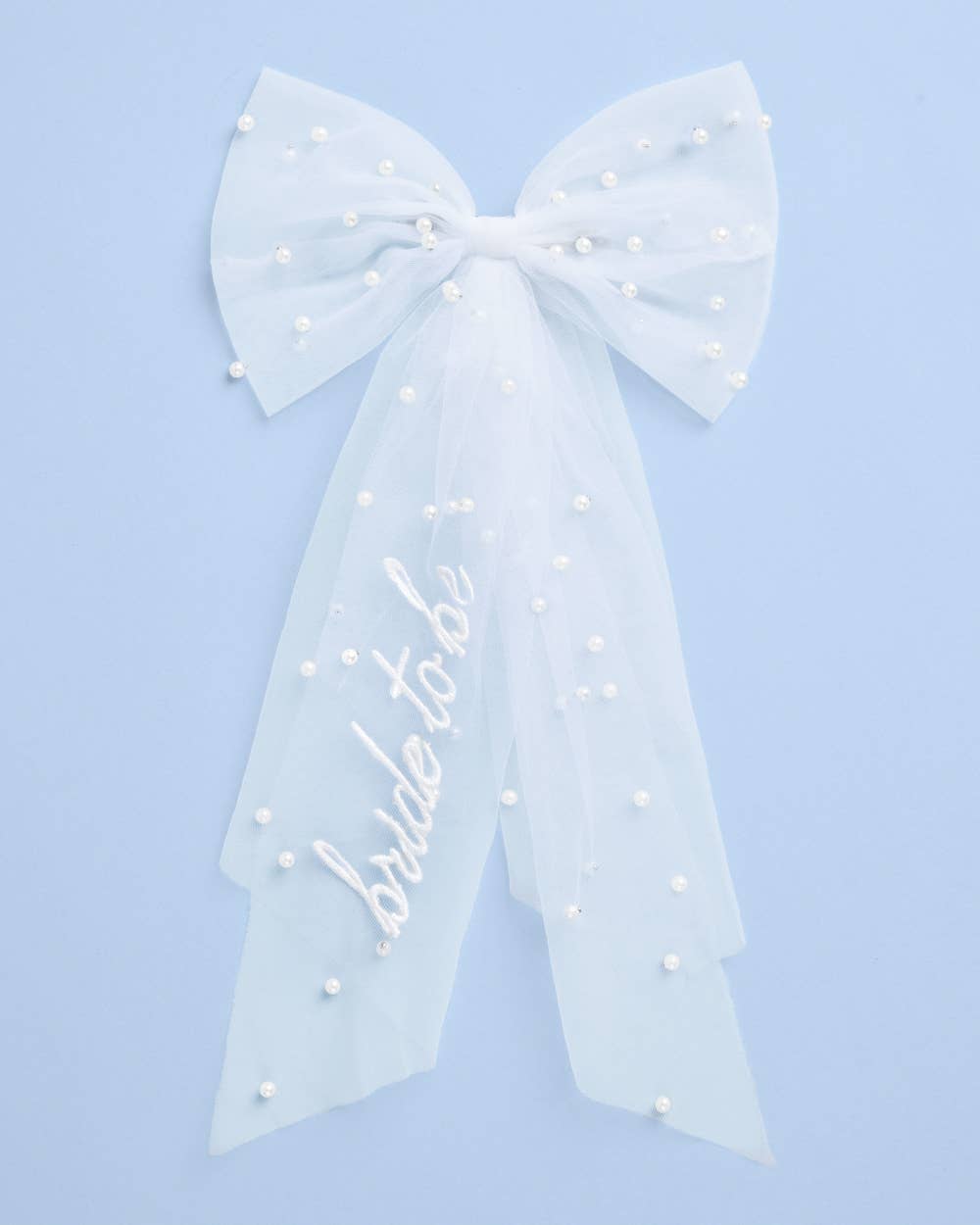 Large decorative bow with 'bride to be' text on a light blue background