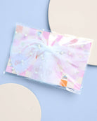 Clear plastic bag with colorful design on a light blue background