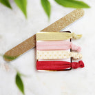 a practical and adorable red with soft pink watercolor wedding survival kit with items brides and bridesmaids need to ensure the wedding day goes smoothly