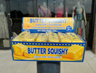 a 4oz yellow butter-stick foam fidget toy made from slow rise polyurethane (PU) foam with a soft texture, classic butter-inspired print, and individual packaging