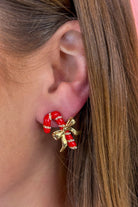 lightweight mirrored statement stud earrings with enamel red and white candy canes, gold bow detailing, and a comfortable post backing