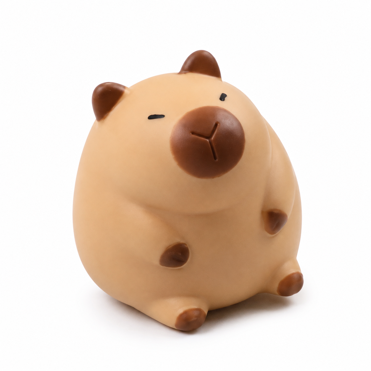a capybara-inspired squishy toy with a rounded tan body, brown accent details, sleepy face, and smooth squeezable texture