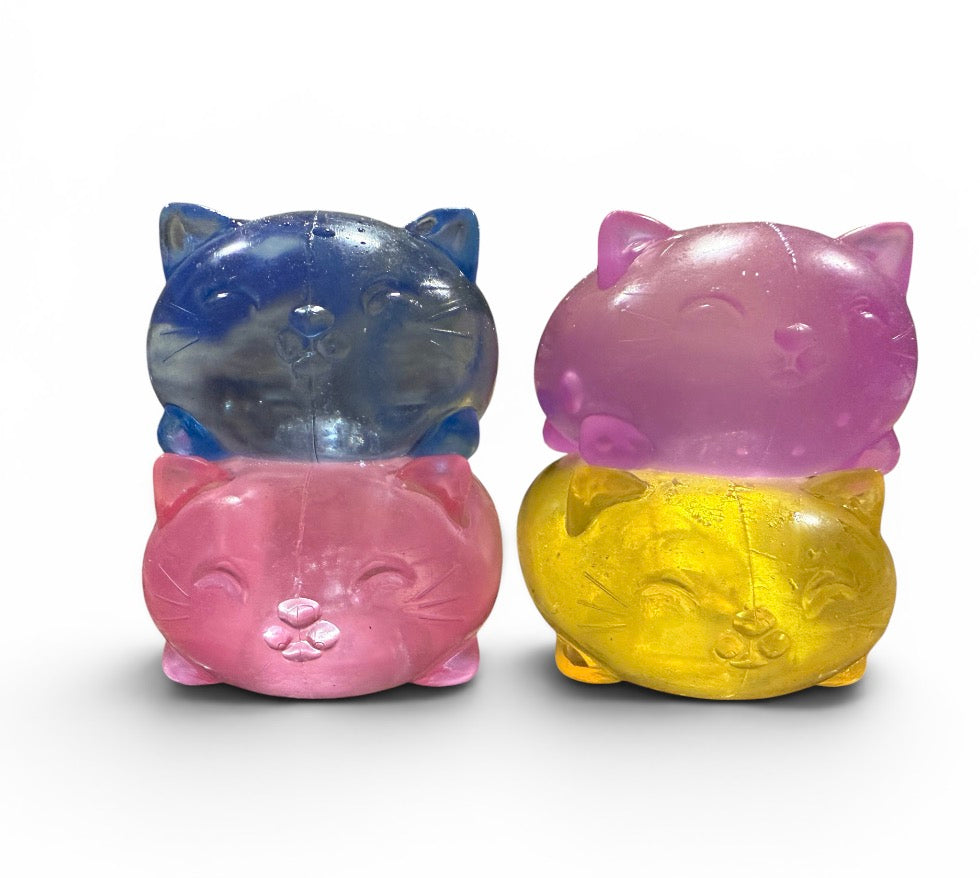 a soft jelly-like chubby kitty squishy with closed eyes, a super slow-rising texture, a stretchy squeezable feel, and a bright translucent color available in blue, pink, purple, and yellow