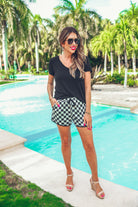 mid-rise, tie waist drawstring, side pockets, & relaxed fit on a black/white checkerboard print