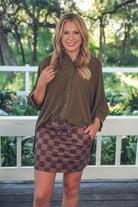 mid-rise relaxed fit everyday skort made of lightweight material with built-in cream shorts, drawstring tie with gold bead accents, an elastic band on the back, and side pockets, designed on a brown on brown pattern print fabric