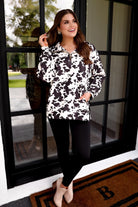 long-sleeve pullover crafted from our best-selling everyday fabric in a bold brown and cream cowhide pattern print, structured collar, functional gold zipper, kangaroo pocket, side slits, and a back yoke seam