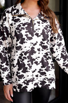 long-sleeve pullover crafted from our best-selling everyday fabric in a bold brown and cream cowhide pattern print, structured collar, functional gold zipper, kangaroo pocket, side slits, and a back yoke seam