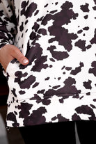 long-sleeve pullover crafted from our best-selling everyday fabric in a bold brown and cream cowhide pattern print, structured collar, functional gold zipper, kangaroo pocket, side slits, and a back yoke seam