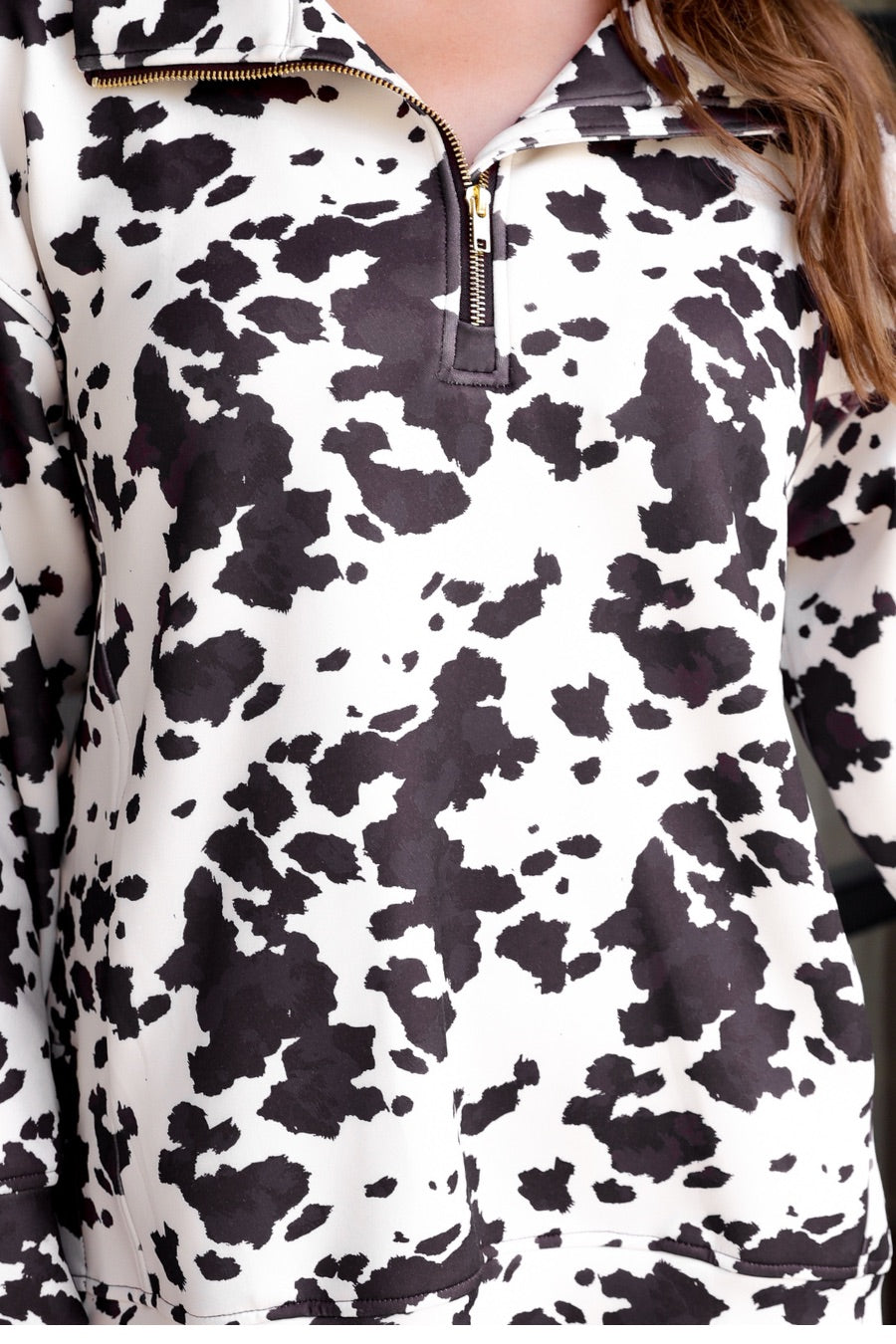 long-sleeve pullover crafted from our best-selling everyday fabric in a bold brown and cream cowhide pattern print, structured collar, functional gold zipper, kangaroo pocket, side slits, and a back yoke seam