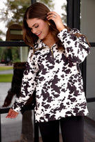 long-sleeve pullover crafted from our best-selling everyday fabric in a bold brown and cream cowhide pattern print, structured collar, functional gold zipper, kangaroo pocket, side slits, and a back yoke seam