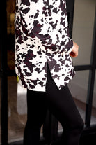 long-sleeve pullover crafted from our best-selling everyday fabric in a bold brown and cream cowhide pattern print, structured collar, functional gold zipper, kangaroo pocket, side slits, and a back yoke seam