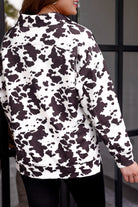 long-sleeve pullover crafted from our best-selling everyday fabric in a bold brown and cream cowhide pattern print, structured collar, functional gold zipper, kangaroo pocket, side slits, and a back yoke seam