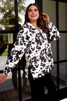 long-sleeve pullover crafted from our best-selling everyday fabric in a bold brown and cream cowhide pattern print, structured collar, functional gold zipper, kangaroo pocket, side slits, and a back yoke seam