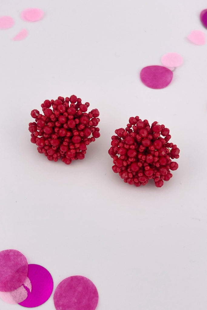 mix of size beads in a pom shape with a clip-on closure