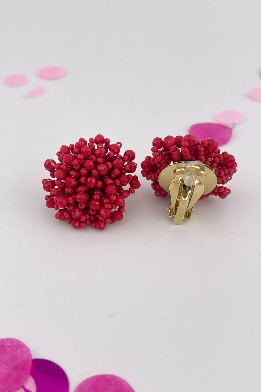 mix of size beads in a pom shape with a clip-on closure