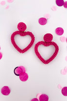 a fuchsia beaded post stud with a matching beaded open heart-shape drop and a comfort earring back in gold