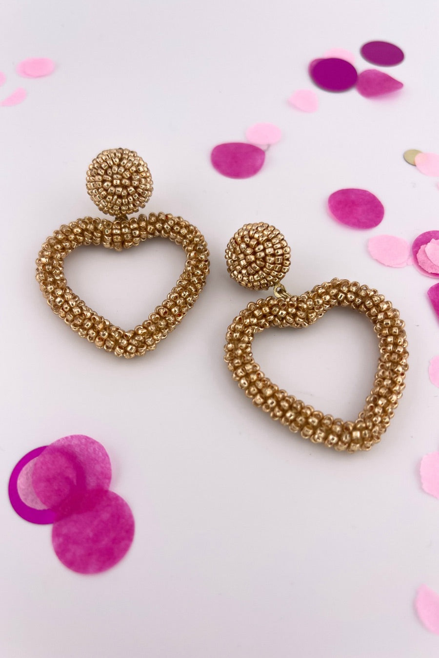 a gold beaded post stud with a matching beaded open heart-shape drop and a comfort earring back in gold