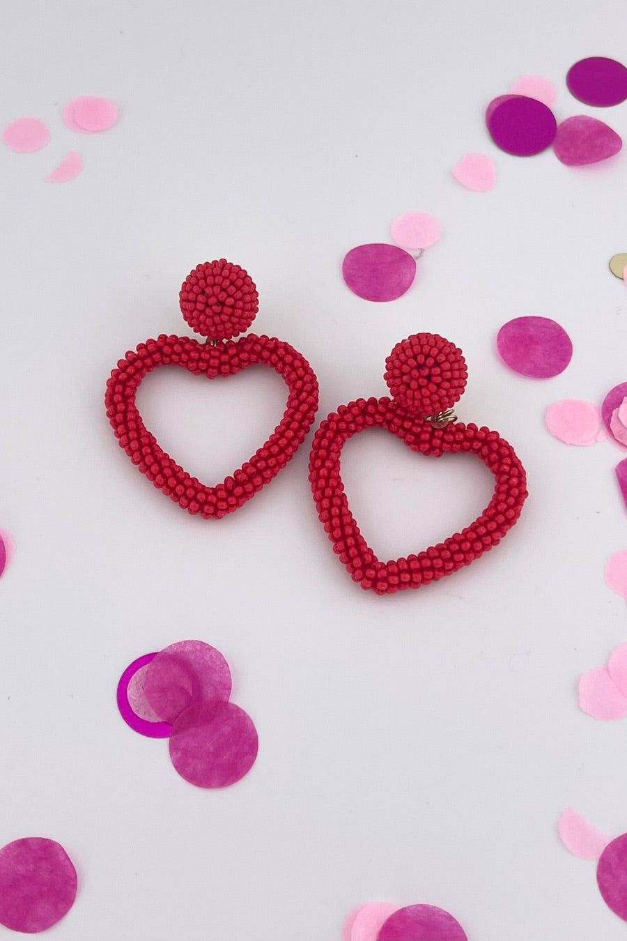 a red beaded post stud with a matching beaded open heart-shape drop and a comfort earring back in gold