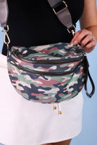 spacious bum bag with double front zippers, a back zipper, an interior zipper pocket, an adjustable strap, and gold hardware accents in cody camo