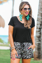 mid-rise, tie waist drawstring, side pockets, & relaxed fit with a leopard print