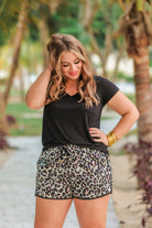 mid-rise, tie waist drawstring, side pockets, & relaxed fit with a leopard print