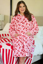 a blanket hoodie with roomy long sleeves finished with soft ribbed cuffs, a slouchy hood, drop shoulder, a kangaroo pouch on ultra plush fabric in Cherry Bomb (Pink)