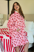 a blanket hoodie with roomy long sleeves finished with soft ribbed cuffs, a slouchy hood, drop shoulder, a kangaroo pouch on ultra plush fabric in Cherry Bomb (Pink)