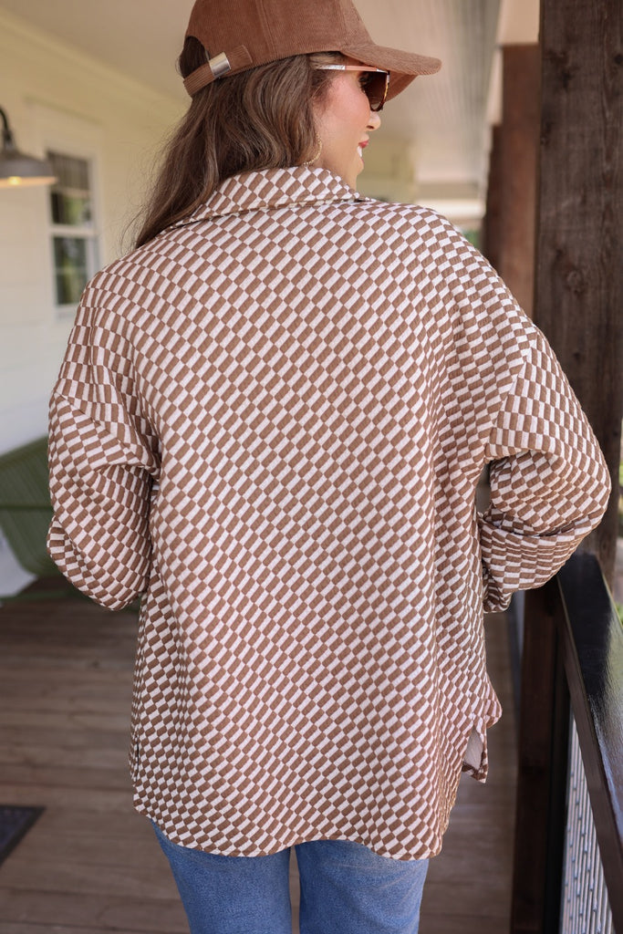 long-sleeve shacket with a foldable collar, button-up open front, and two chest pockets on a tan and white textured fabric