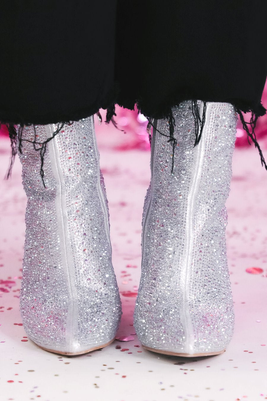 rhinestone-covered booties with a pointed toe, front seam, inside zipper, cushioned flatbed, and a 4" block heel in silver