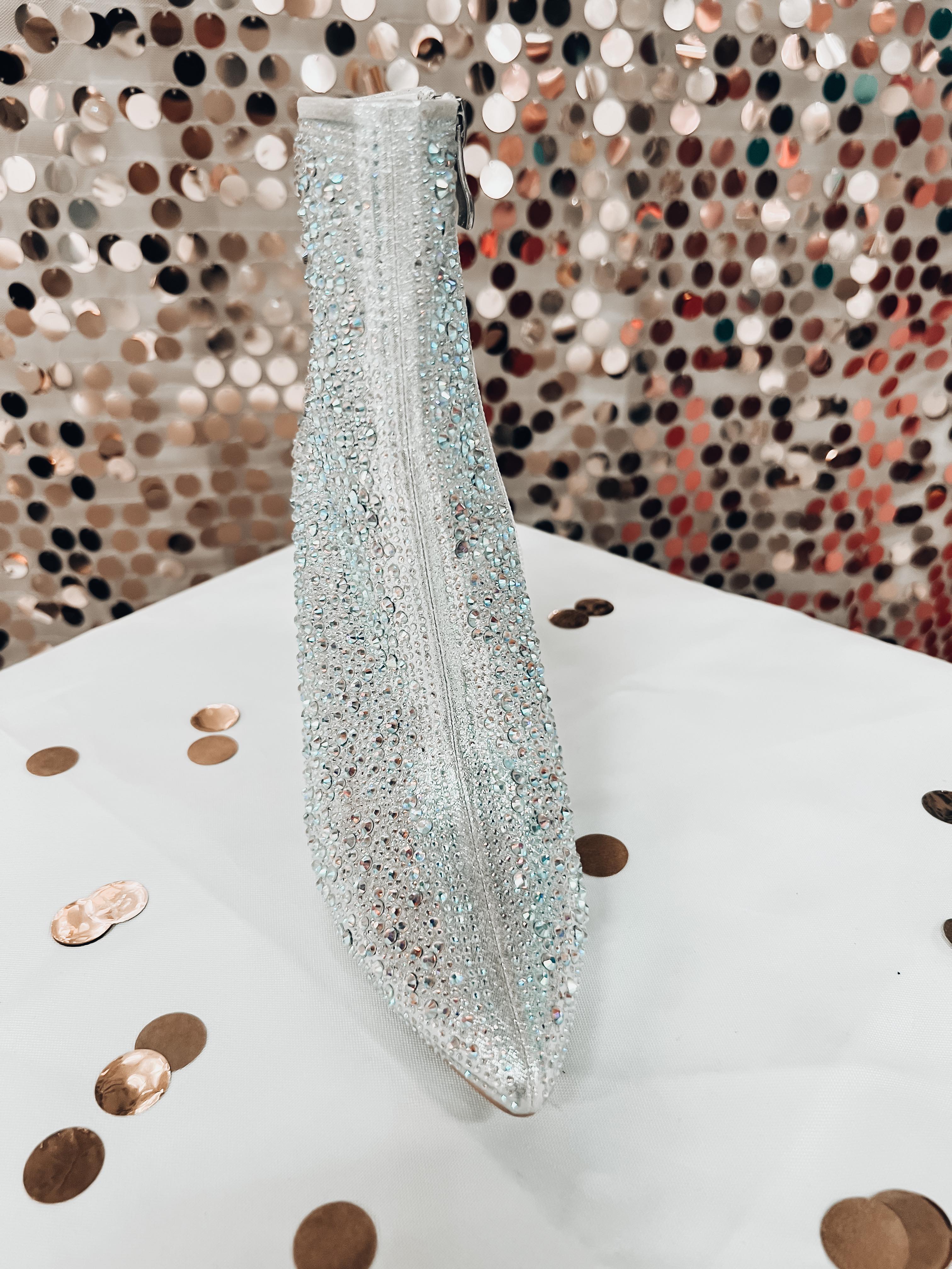 rhinestone-covered booties with a pointed toe, front seam, inside zipper, cushioned flatbed, and a 4" block heel in silver
