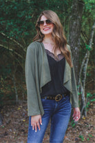 draped open-front silhouette jacket, crafted on a super soft faux suede material with long sleeves, an angled front cropped hem, and subtle seam details on the back in olive
