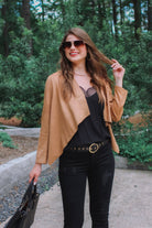 draped open-front silhouette jacket, crafted on a super soft faux suede material with long sleeves, an angled front cropped hem, and subtle seam details on the back in camel