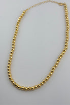 a gold-plated necklace with 6mm brass beads