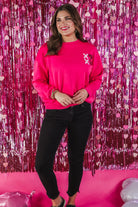 pink long sleeve soft sweatshirt with sequin stacked XOXO on the left chest