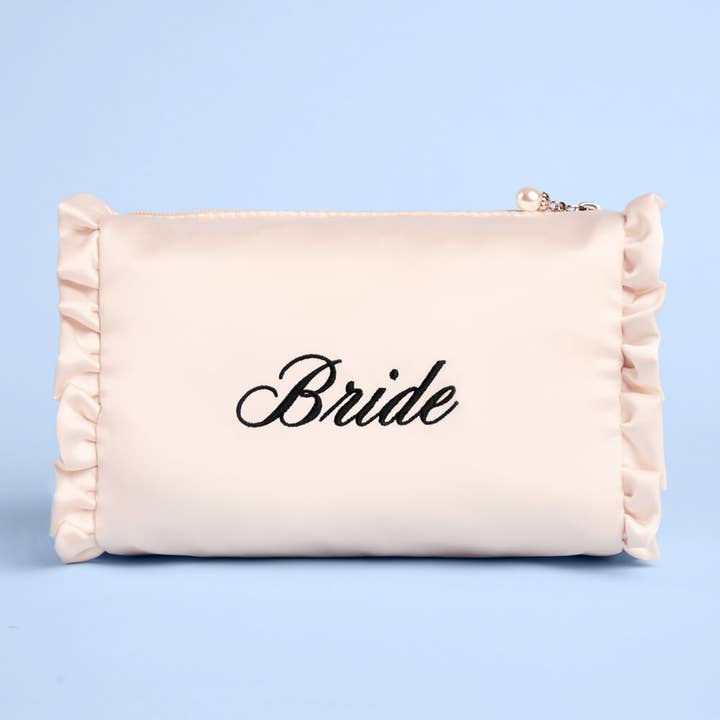 Beige pouch with 'Bride' embroidery on a light blue background