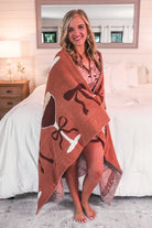 ultra-soft throw on a martini and bow pattern print fabric in brown
