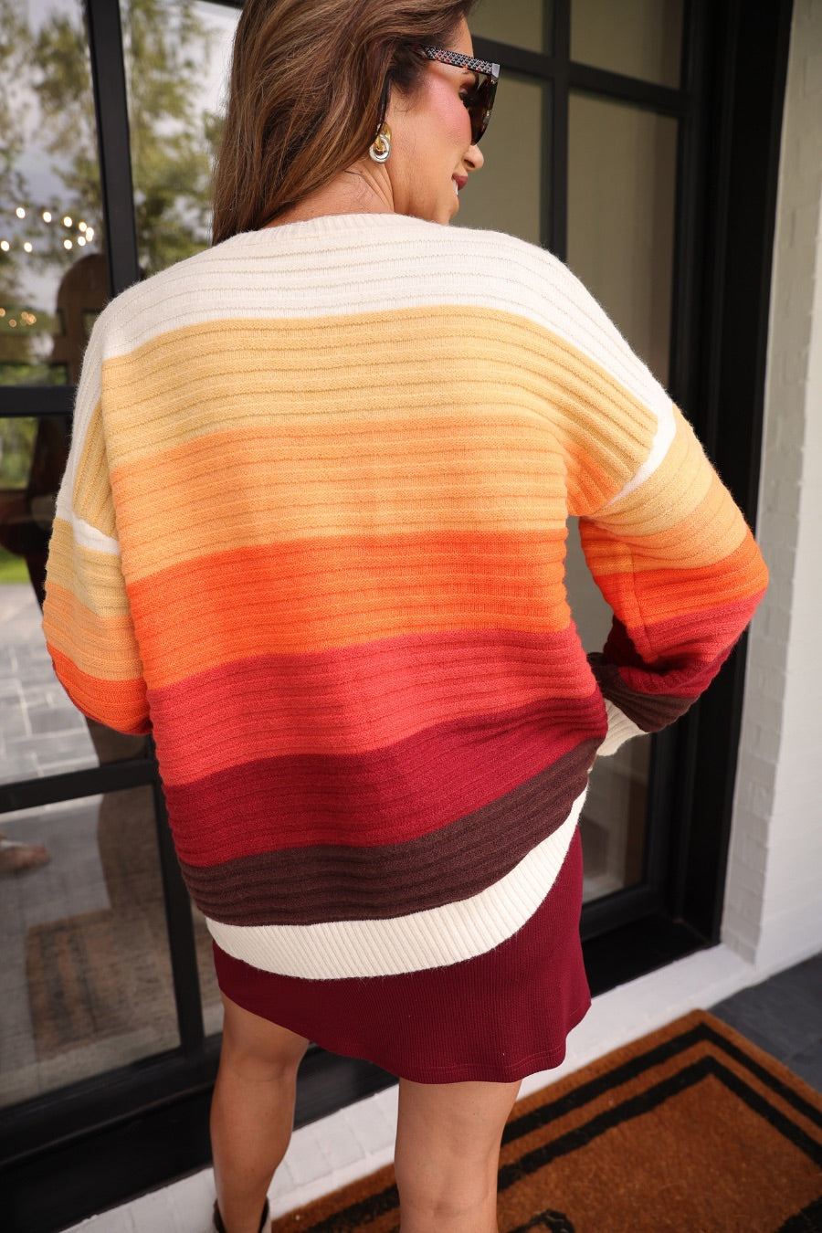 long-sleeve open front cardigan, finished in a vibrant ombré of cream, gold, orange, and rust tones on a soft knit fabric