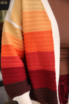 long-sleeve open front cardigan, finished in a vibrant ombré of cream, gold, orange, and rust tones on a soft knit fabric
