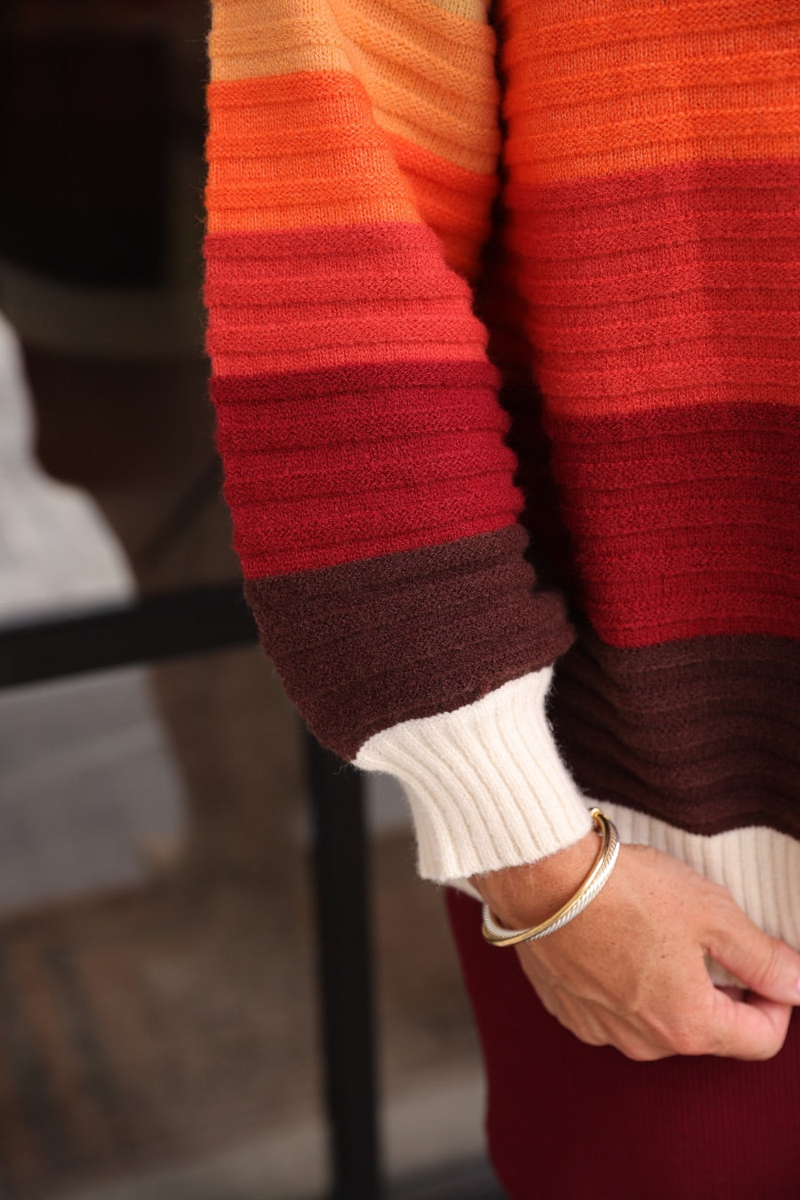 long-sleeve open front cardigan, finished in a vibrant ombré of cream, gold, orange, and rust tones on a soft knit fabric