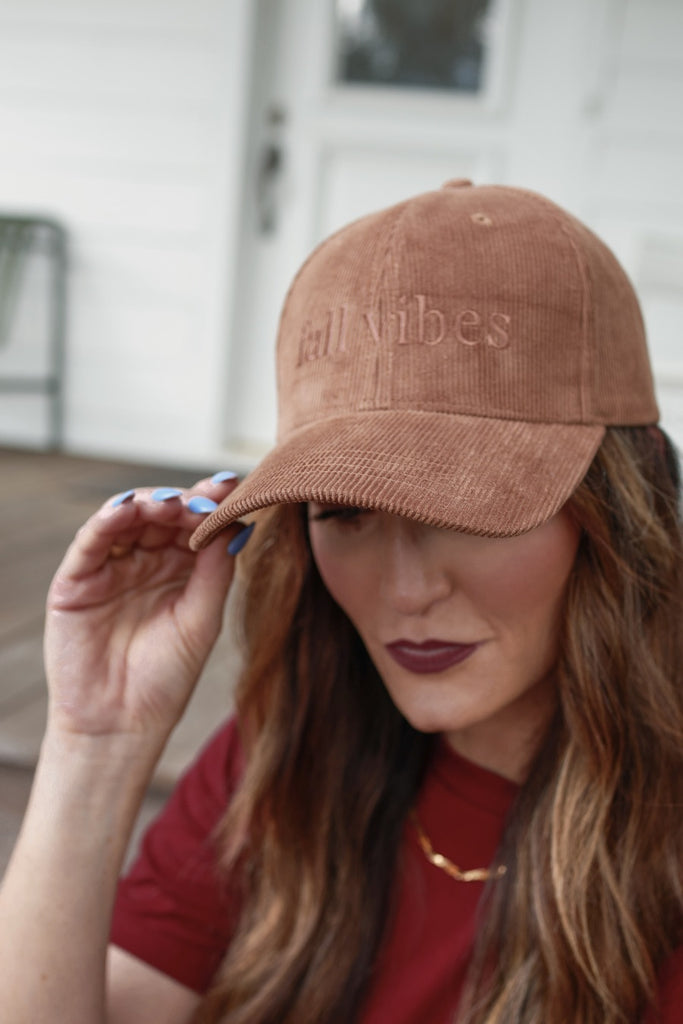 soft corduroy fabric in a warm neutral color with FALL VIBES embroidered lettering in lowercase letters