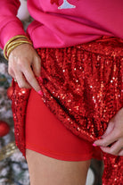 a tiered design skort with built-in shorts, an elastic waistband, and a drawstring tie on a red sequin fabric