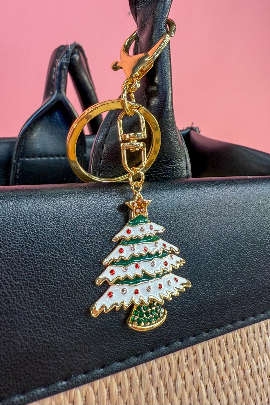 a festive layered green enamel fir Christmas tree with snowy white detailing, sprinkled with red and crystal accents, and crowned with a shimmering gold star, complete with a gold-tone swivel clasp and matching keyring
