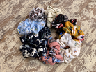 oversized floral scrunchies with lightweight textured fabric, gathered construction, gentle hair-friendly hold, and easy pull-on styling in banana, black, butterscotch, cream, mauve, navy cream, navy teal, sky, and white