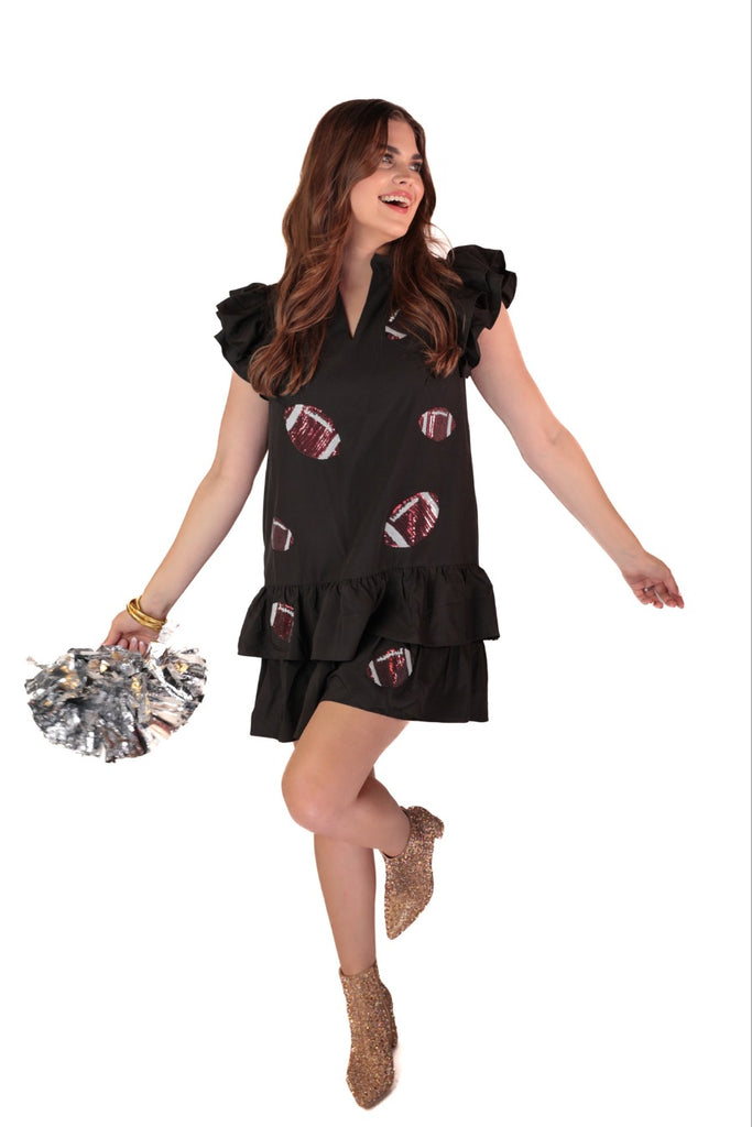 frilly ruffle sleeves & a tiered ruffle bottom adorned with a sequin football pattern on black fabric